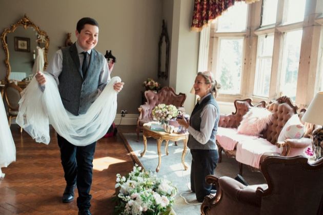 Page boy carries bride's veil