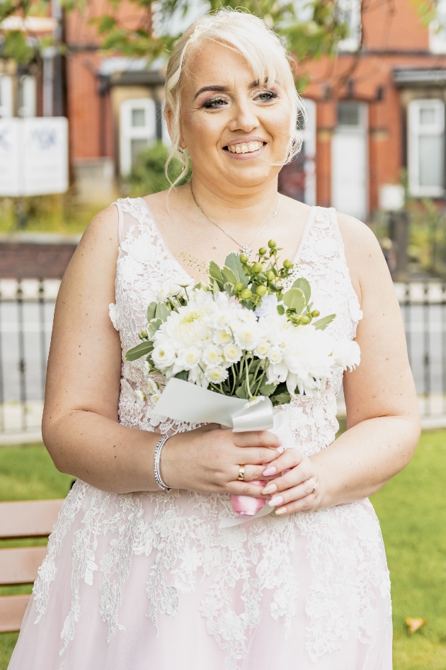 Bride in her wedding dress holding her wedding bouquet