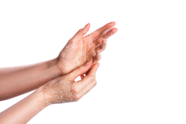 exfoliating hands with a scrub