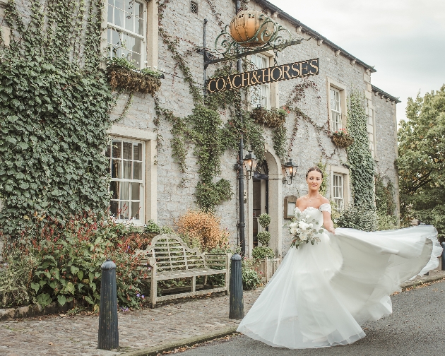 A bride standing outside The Coach & Horses