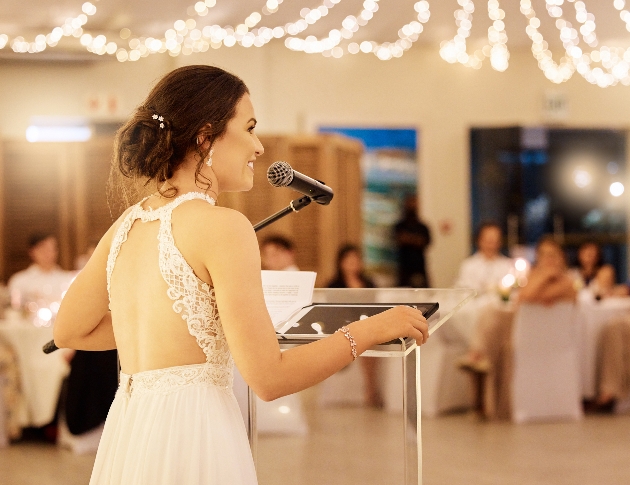 bride giving a speech at wedding reception