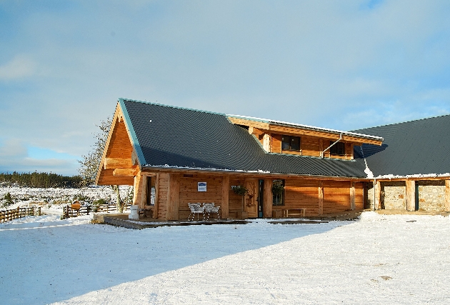 The exterior of a wooden building with snow on the ground