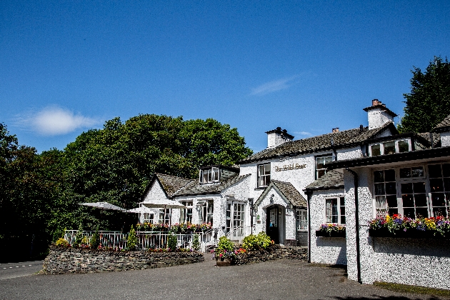 The exterior of a large white building with an outdoor seating area