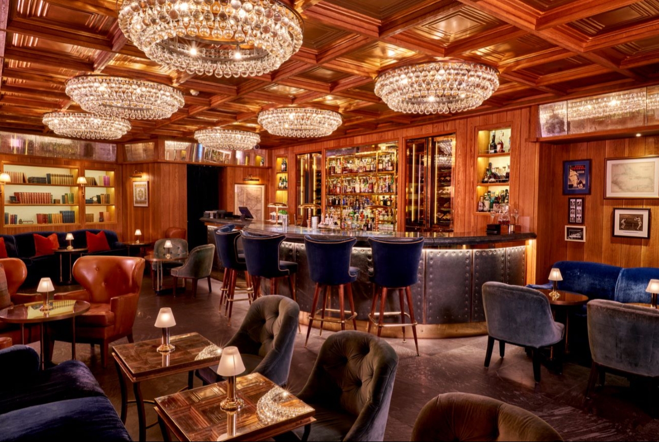 woodpanelled bar with chandeliers on ceiling
