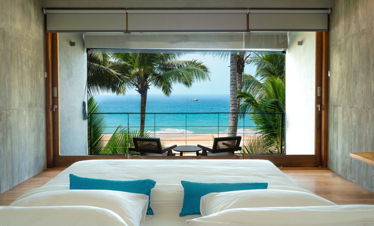 king-size bedroom overlooking balcony and beach