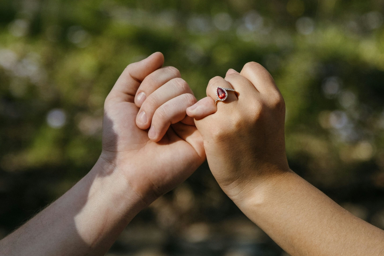 Man and woman interlocking pinkies