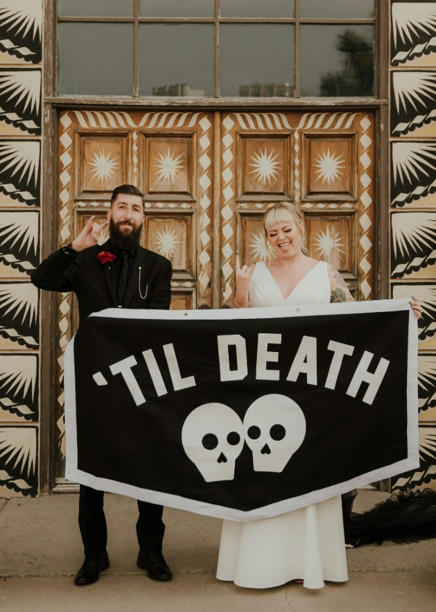 Til' death do us part sign with wedding couple holding it
