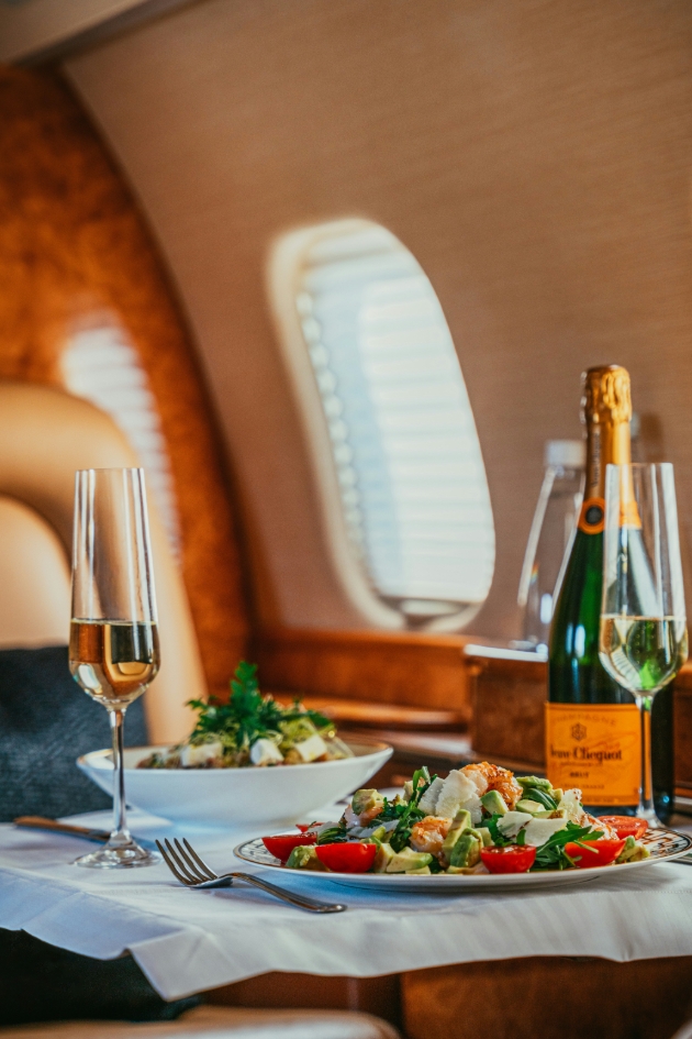 meal served with champagne on private jet