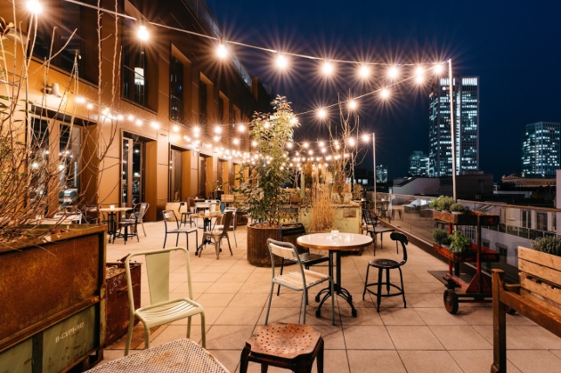 night-time shot of roof terrace with festoon lights on
