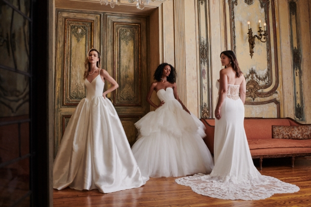 group of women posing in wedding dresses