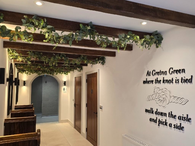 hallway shot of wedding themed toilets