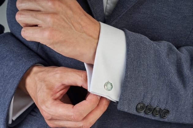 A man adjusting a cufflink