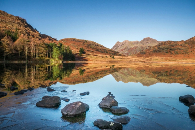 A lake with mountains in the background