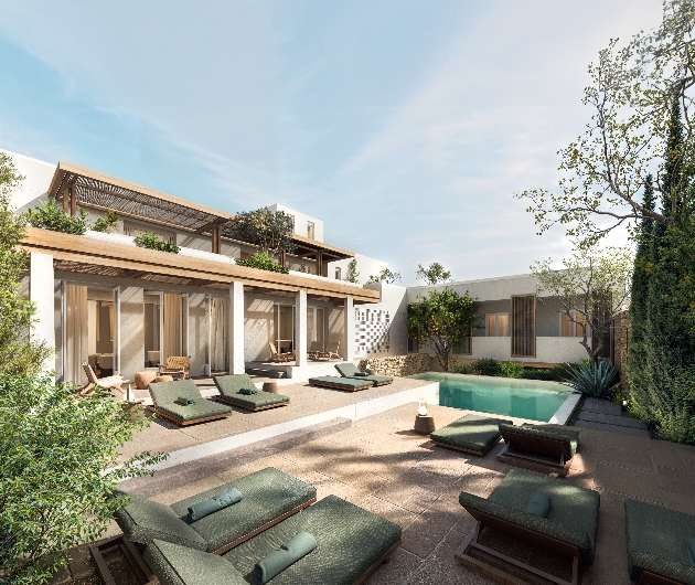 An outdoor pool with a white villa in the background
