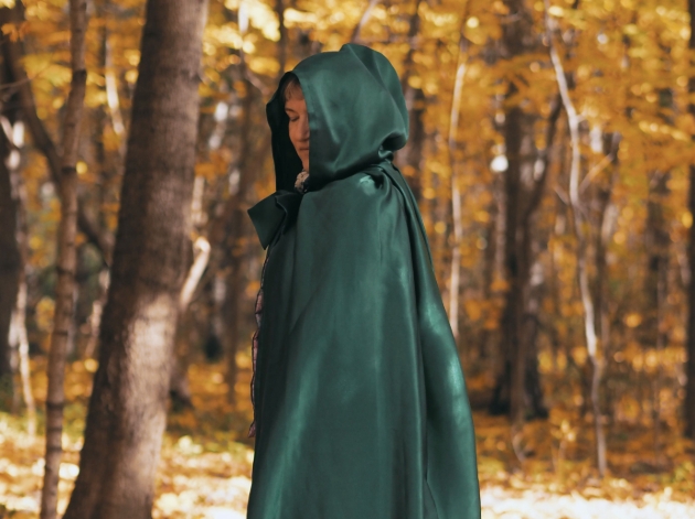 woman in green hood